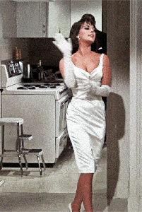 a woman in a white dress is standing in a kitchen