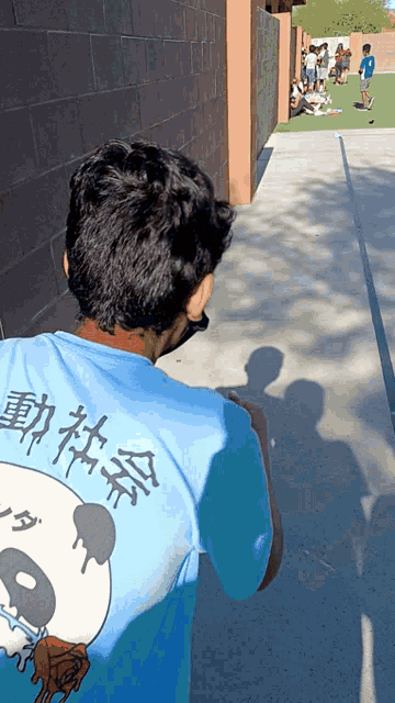a man in a blue shirt with a panda on it