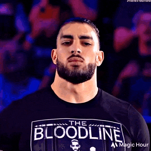 a man with a beard is wearing a shirt that says the bloodline