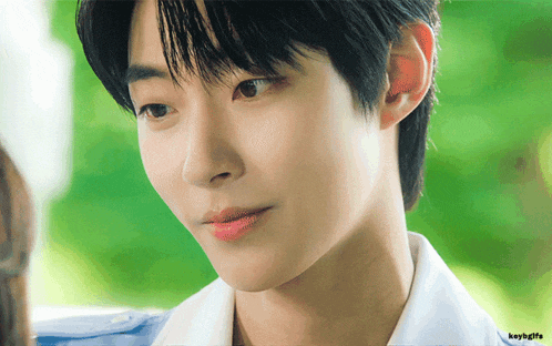 a close up of a young man 's face with the words keybygfs below