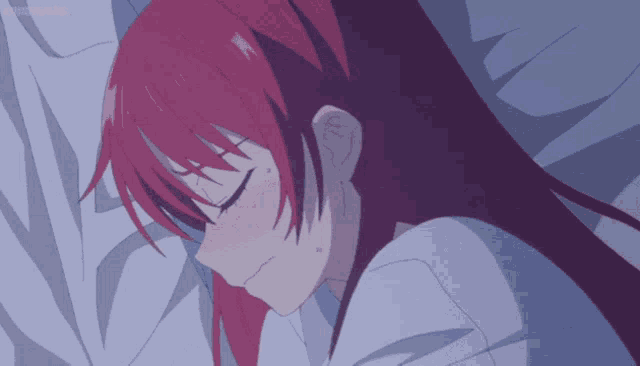 a girl with red hair is sleeping on a bed