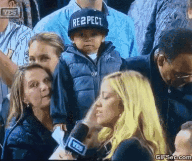 a young boy wearing a hat that says respect is being interviewed by a woman