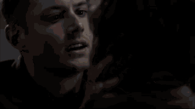 a man wearing a watch is hugging another man with tears running down his face