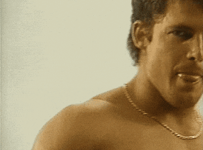 a shirtless man with a chain around his neck