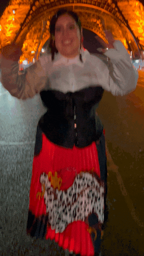 a woman wearing a red and black skirt with a leopard print