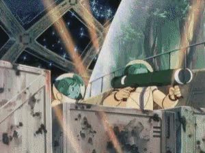 a man in a green helmet is holding a rocket in his hand .