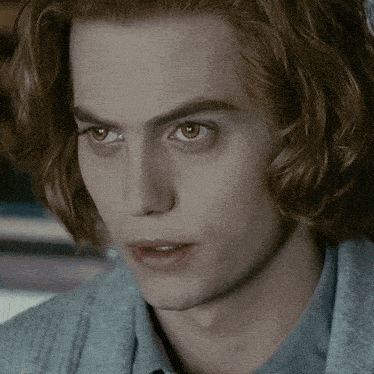 a close up of a young man with red hair