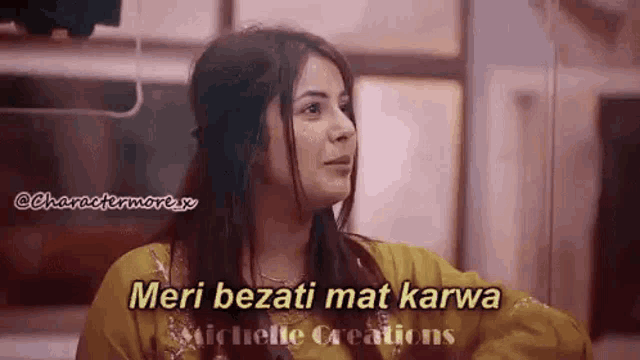 a woman in a yellow dress is talking to another woman in a kitchen .