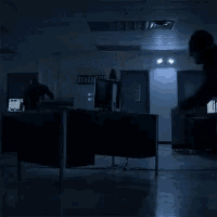 a dark room with a fire extinguisher on the ground