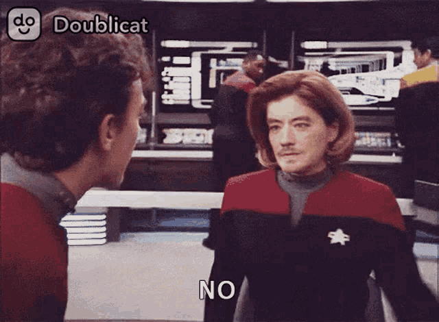 a man and a woman are standing next to each other and the woman is saying no