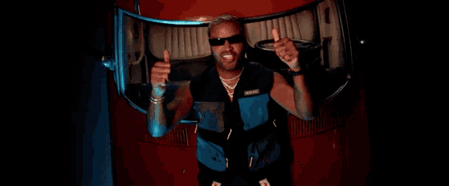 a man wearing sunglasses and a vest that says mike