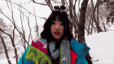 a woman wearing a blue jacket and a scarf that says ' ski ' on it