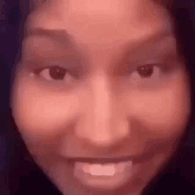 a close up of a woman 's face with a cartoon face on it .