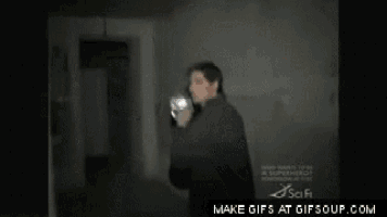 a gif of a man holding a camera with the words make gifs at gifsoup.com below him