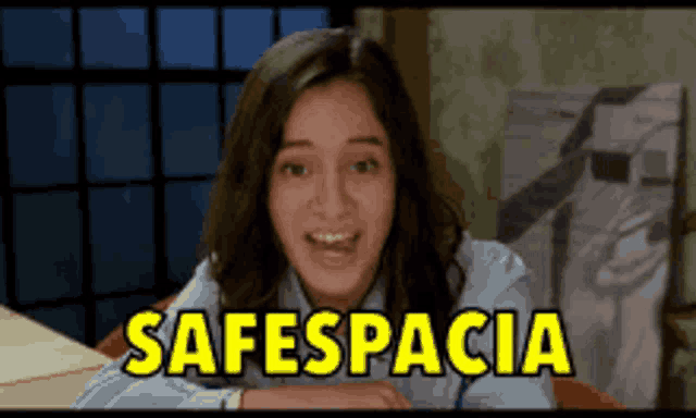 a girl is smiling in front of a screen that says safespacioa