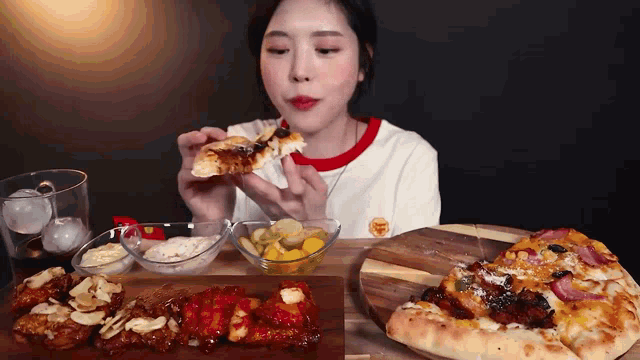 a woman is sitting at a table eating pizza