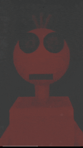 a statue of a red robot with a crown on its head