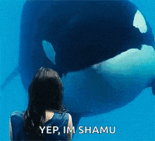 a woman looking at a killer whale with the words yep im shamu written on the bottom
