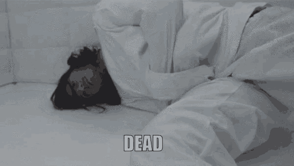 a person in a straight jacket is laying on the floor and the word dead is above them