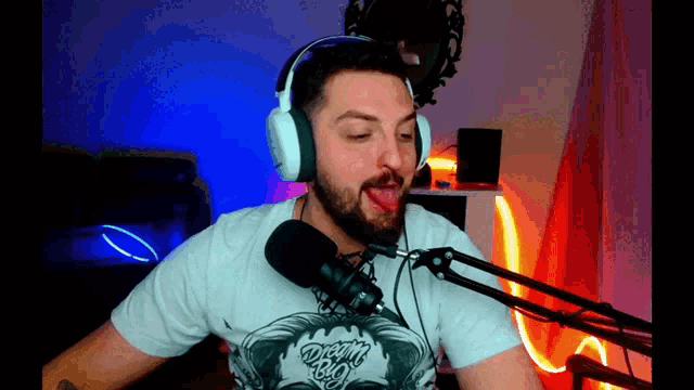 a man with a beard wearing headphones and a t-shirt that says devils on it