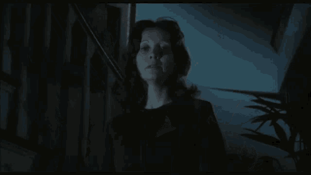 a close up of a woman 's face in a dark room