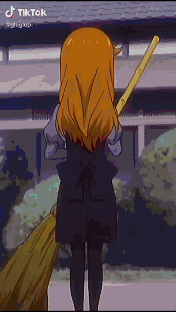 a girl with long blonde hair is holding a broom in her hands .