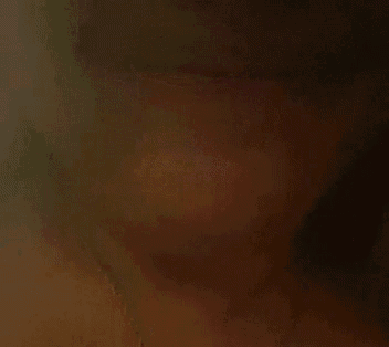 a close up of a person 's face with a brown background .