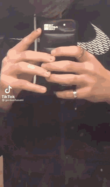 a person is taking a picture of themselves in a mirror while wearing a ring .