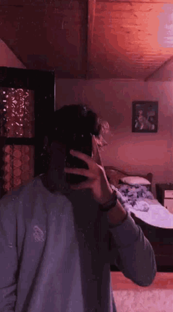 a person is taking a picture of themselves in a bedroom