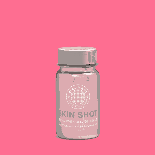 a bottle of beauty & go skin shot against a pink background
