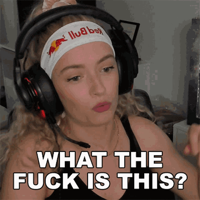 a woman wearing headphones and a headband with a red bull logo on it says what the fuck is this