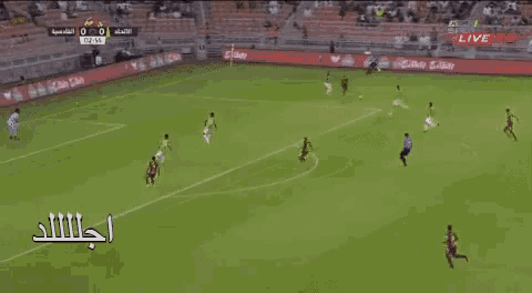 a soccer game is being played in a stadium and the score is 0 to 1