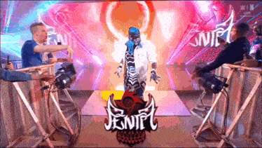 a wrestler is standing in front of a sign that says jenife