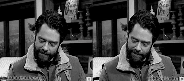 a black and white photo of a man with a beard and a jacket .