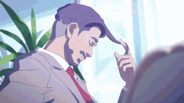a man with purple hair and a red tie looks down