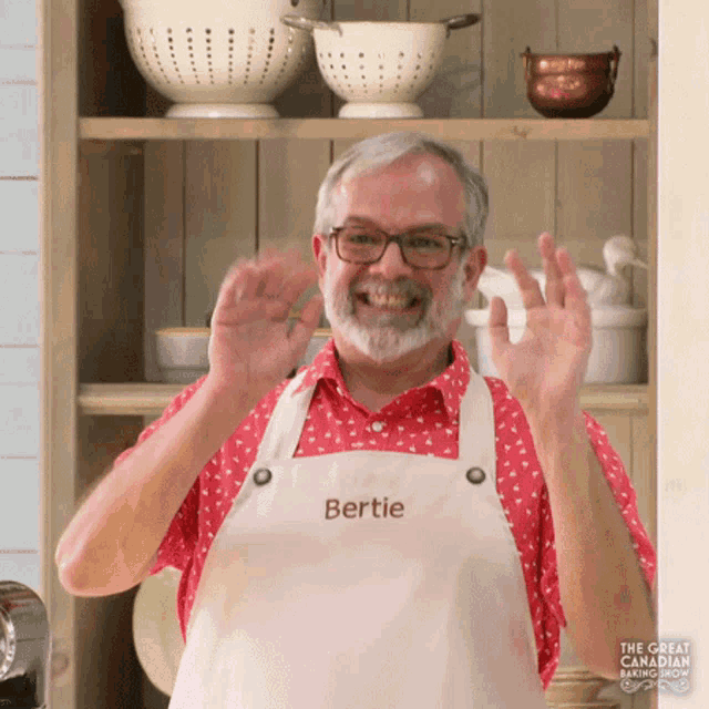 a man wearing an apron that has the name bertie on it