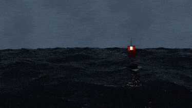 a red buoy is in the middle of a stormy ocean