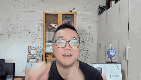 a man wearing glasses is making a funny face in front of a whiteboard .