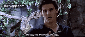 a man is holding a knife in front of a statue and says no weapons , no friends , no hope .
