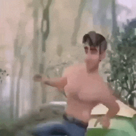 a man without a shirt is dancing in a blurry picture .