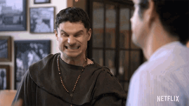 a man making a funny face with a netflix logo in the background