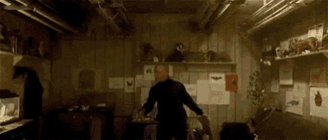 a man is standing in a room filled with stuffed animals .