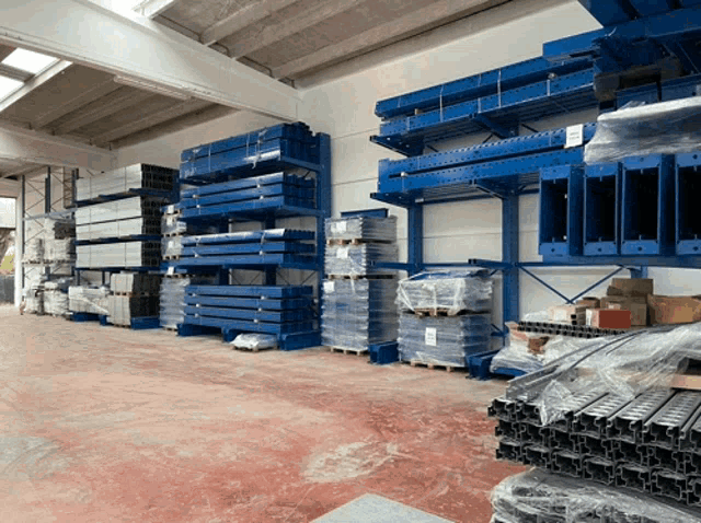 a warehouse filled with lots of blue shelves and pallets