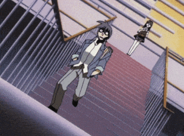 a man is walking down a set of stairs with a girl standing behind him