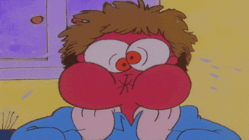 a close up of a cartoon character 's face with big eyes