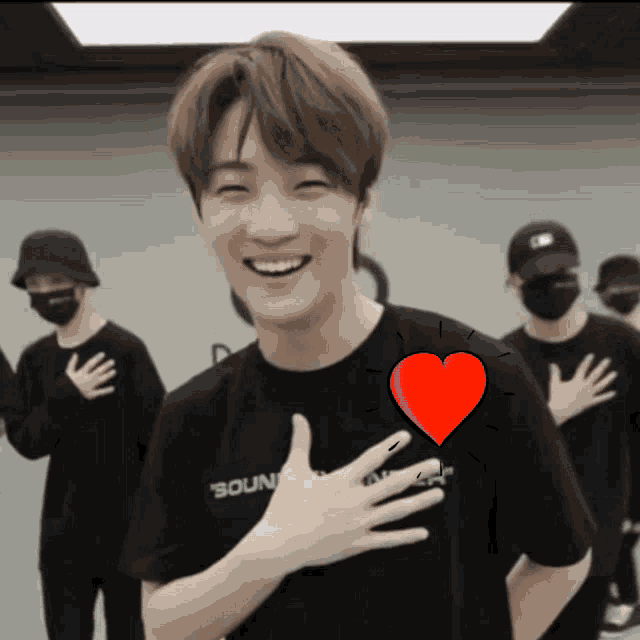 a man wearing a black shirt that says " sound " on it