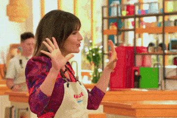 a woman wearing a white apron that says maggie