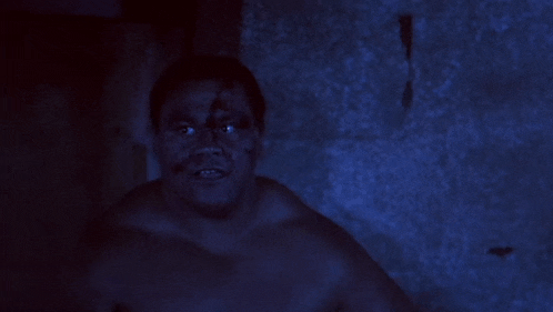 a shirtless man says sorry man can 't play no more in a dark room