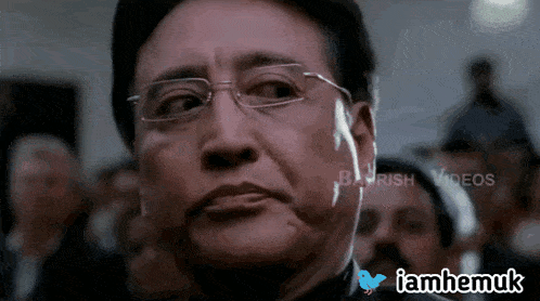 a blurred image of a man 's face with the words iamhemuk on the bottom
