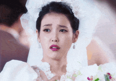 a woman in a white wedding dress with a veil